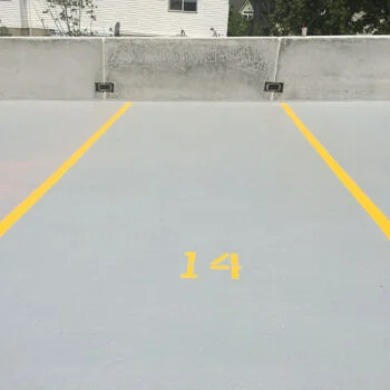 waterproofing traffic membrane applied to outdoor parking deck of a parking garage