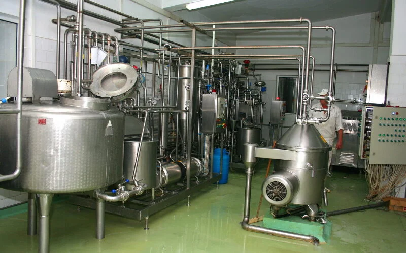 dairy bottling plant machinery in a facility using antibacterial and antimicrobial waterproof floors seamless epoxy overlay for food and beverage