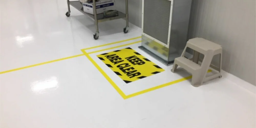epoxy floors with signage "keep areea clear" design embedded beneath the epoxy floor sealant