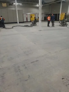 Grinding concrete to prepare surface and expose surface cracks